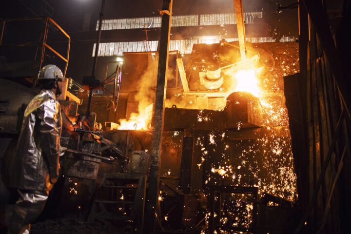 Photo of a steel mill worker wearing a silver reflective fire retardant suit.